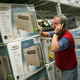 Customer Service Associate talks to a customer on the phone regarding available in-window air conditioners at the Lowe’s home improvement store August 2, 2006 in Arlington Heights, Illinois during a heat wave.